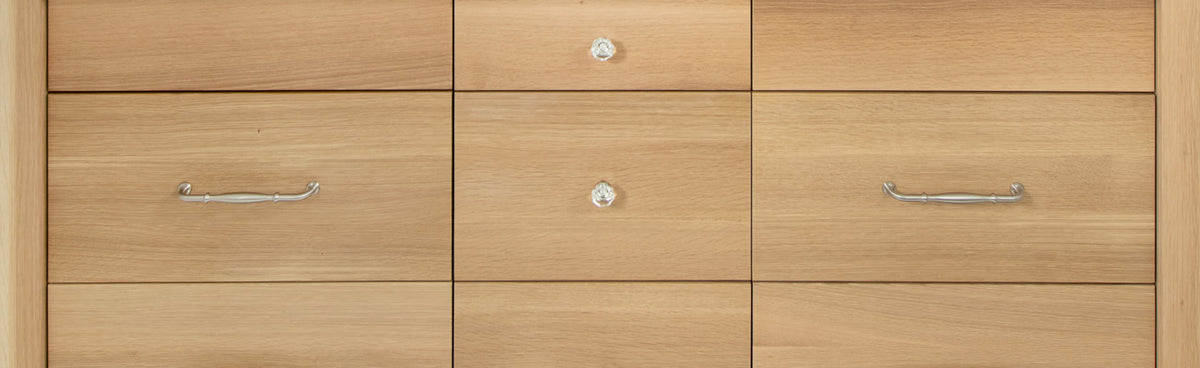 White oak vanity drawers with brushed nickel pulls and crystal knobs